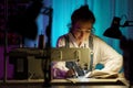 Self-employed young woman work on sewing machine in little creative atelier creating bespoke clothes Royalty Free Stock Photo