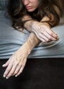 Self harm on frustrated disillusioned sick woman lying on bed with heavy self inflicted Cuts and scars of self-mutilation in Royalty Free Stock Photo