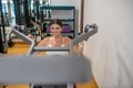 Smiling woman strengthening her hands in a gym