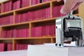 Self-inking, rubber date stamp on the table in the library. Royalty Free Stock Photo