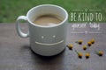 Self Inspirational motivational quote - Be kind to yourself. With smiling mug of white coffee on wooden table and little flowers Royalty Free Stock Photo