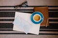 Self-isolation working at home flat lay: leather book, open blank pages of paper notebook, a pencil, glasses, medic mask and a cup Royalty Free Stock Photo