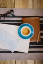 Self-isolation working at home flat lay: leather book, open blank pages of paper notebook, a pencil, glasses, medic mask and a cup Royalty Free Stock Photo