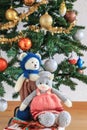 Self knitted kitty cat and teddy bear under the beautiful Christmas tree Royalty Free Stock Photo