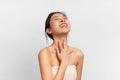 Beauty portrait of young Asian woman touching her neck Royalty Free Stock Photo