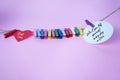 What you tell yourself every day matters. Self love care concept with colorful clips on pink background.