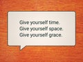 Self love and care motivational words - Give yourself time, give yourself space and grace. With advice sign on orange background.