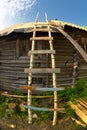 Self made old wooden ladder near the rural house wall Royalty Free Stock Photo