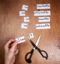 Self motivation concept. Negative words cut with scissors.