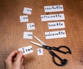 Self motivation concept. Negative words cut with scissors.