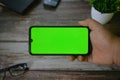 Self Perspective smartphone In the hands of a man with green screen for key chroma screen Royalty Free Stock Photo