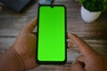 Self Perspective smartphone In the hands of a man with green screen for key chroma screen Royalty Free Stock Photo