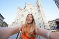 Self portrait of beautiful traveler woman smiling at camera in front of the Cathedral on sunset in Florence, Italy Royalty Free Stock Photo