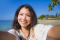 Self portrait of gorgeous beautiful and happy Asian Korean or Chinese woman 20s taking selfie photo with mobile phone camera in ex Royalty Free Stock Photo