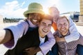 Self portrait of smiling group of young people taking selfie with phone outdoors Royalty Free Stock Photo