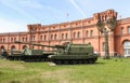 Self-propelled howitzers on the background of the military-historical museum.