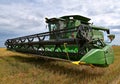 Self Propelled 9770 ST John Deere combine parked in wheat stubble Royalty Free Stock Photo