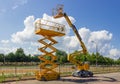 Self propelled wheeled articulated boom lift and scissor lift Royalty Free Stock Photo