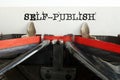 Self-publish text typed on retro typewriter. Business and self publish concept Royalty Free Stock Photo