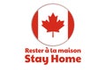 Self quarantine and and social distancing concept. Inscription Stay Home in French. Flag of Canada. COVID-19 coronavirus