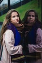 Self reflection portrait of amazing young girl in mirrored window. Unusual strange pretty woman person with sensual face looking Royalty Free Stock Photo