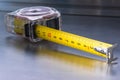 Self-retracting metal tape measure