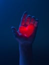 Human Hand Holding Red Luminous Heart. Proposal. Surprise. Giving Love And Affection To Beloved. 3d rendering.