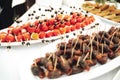 Self-service buffet table with various types of small snacks. Focused on stuffed cherry tomatoes with cheese Royalty Free Stock Photo