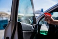 self-service car wash. a man washes the car window with glass cleaning liquid Royalty Free Stock Photo