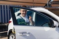 self-service car wash. a man washes the car window with glass cleaning liquid Royalty Free Stock Photo