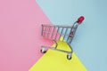 Self-service supermarket full shopping trolley cart on colorful background