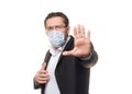 Selfhelp of coronavirus pandemics. European middle-aged man in formal office wear with protective medical mask makes a Royalty Free Stock Photo