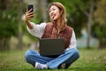 Selfie, asian and woman student in a park to update social media while outdoor studying and learning online. Internet Royalty Free Stock Photo