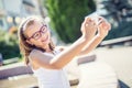 Selfie. Beautiful cute young girl with braces and glasses laughing for a selfie