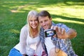 Selfie, camera and couple in a park, love and happiness with marriage and romance with summer or nature. Photograph Royalty Free Stock Photo