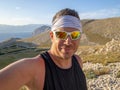 Selfie of cool trailrunning man in croatia on the island krk in baska in summer