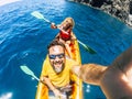 Selfie couple with top vertical point of view - happy active adult people enjoy kayak at the ocean - summer tourist in holiday