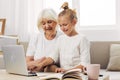 Selfie education video togetherness sofa granddaughter hugging grandmother bonding child smiling call family laptop Royalty Free Stock Photo