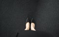 Selfie of feet and legs shoes black high heel on road city street floor background. Top view of business woman standing wearing Royalty Free Stock Photo