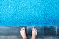 Selfie the feet at the pool side or edge with blue mosaic tiles Royalty Free Stock Photo