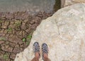 Selfie of feet Traveler men with hiking sandals standing on On the Big white stone. Royalty Free Stock Photo