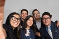 selfie group of an office teamwork, smiling business team hispanic young coworking people in formal outfit Royalty Free Stock Photo