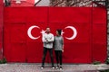 Selfie of a guy and a girl on the background of the flag