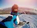 Selfie Guy sportsman goes on normal skiing on ski slope with action camera Sheregesh Royalty Free Stock Photo