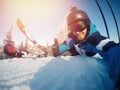 Selfie Guy sportsman goes on normal skiing on ski slope with action camera. Sunset. winter Royalty Free Stock Photo