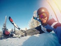 Selfie Guy sportsman goes on normal skiing on ski slope with action camera. Sunset. winter Royalty Free Stock Photo