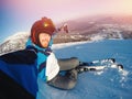 Selfie Guy sportsman goes on normal skiing on ski slope with action camera. Sunset. winter Royalty Free Stock Photo