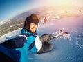 Selfie Guy sportsman goes on normal skiing on ski slope with action camera. Sunset. winter Royalty Free Stock Photo