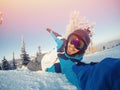 Selfie Guy sportsman goes on normal skiing on ski slope with action camera. Sunset. winter Royalty Free Stock Photo