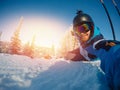 Selfie Guy sportsman goes on normal skiing on ski slope with action camera. Sunset. winter Royalty Free Stock Photo